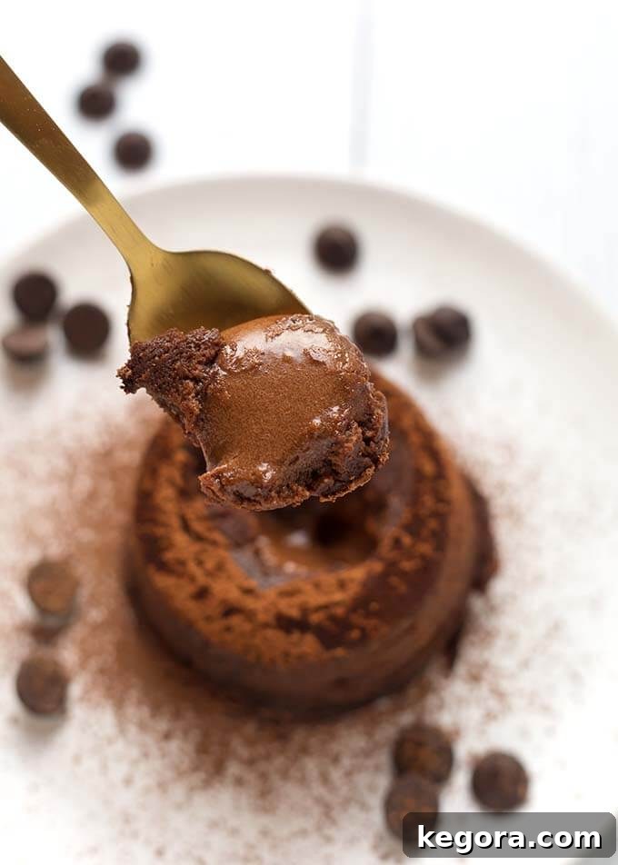 Decadent Instant Pot Chocolate Lava Cake 4 Closeup of spoonful of Chocolate Lava Cake over a white plate