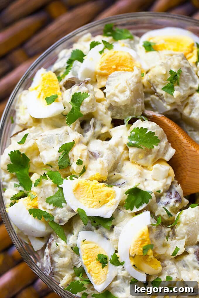 Effortless Instant Pot Potato Salad 2 Close up of Easy Instant Pot Potato Salad with wooden spoon in glass bowl