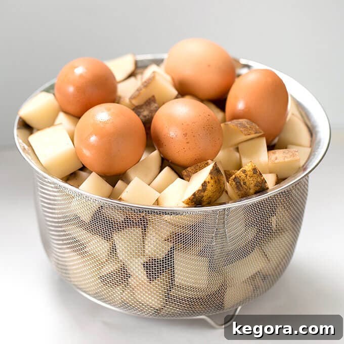 Effortless Instant Pot Potato Salad 3 mesh basket of diced potatoes and five brown eggs
