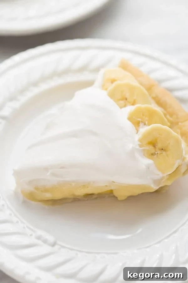 Decadent Gluten-Free Vegan Banana Cream Pie 2 close up shot of sliced banana cream pie on white plate