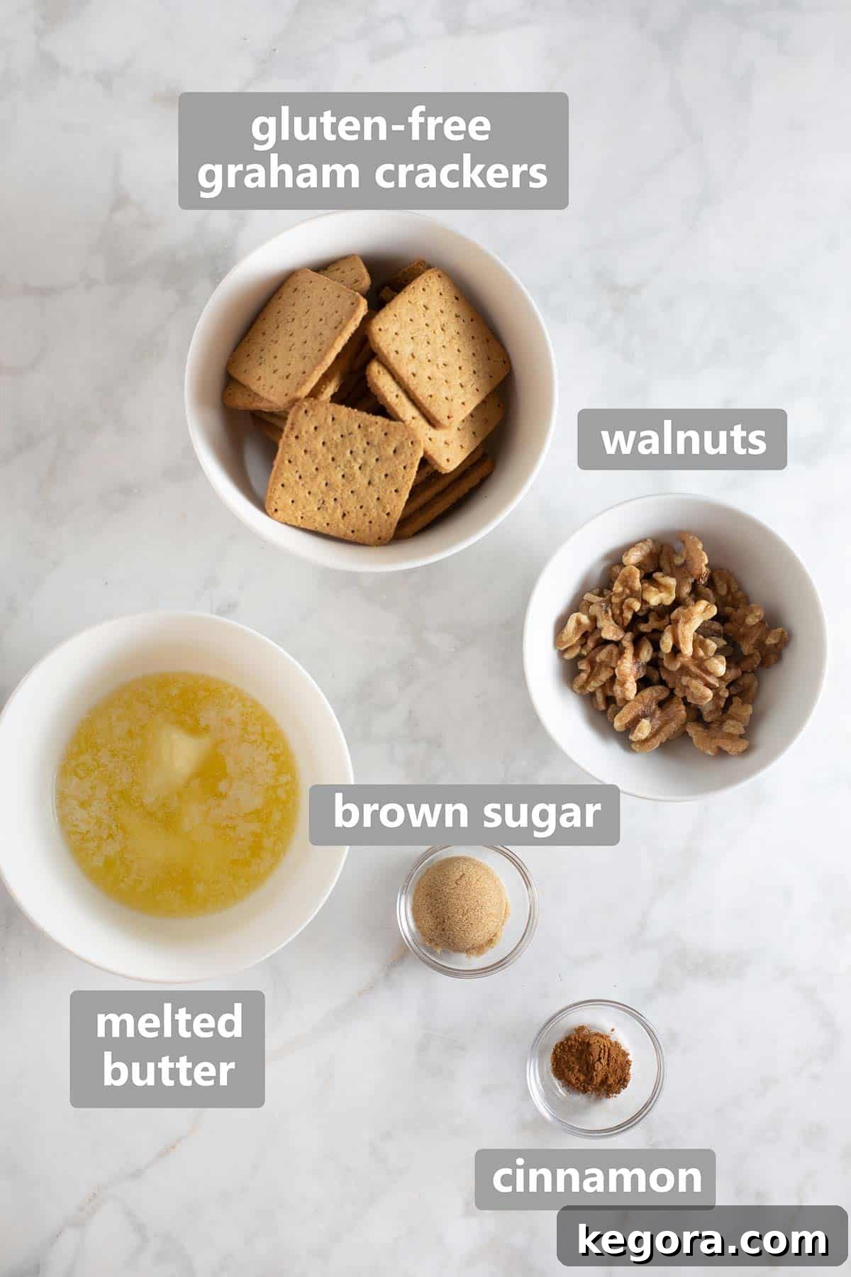 Decadent Gluten-Free Pumpkin Cheesecake 3 Overhead shot of ingredients for gluten-free cheesecake crust including graham crackers, walnuts, and butter.