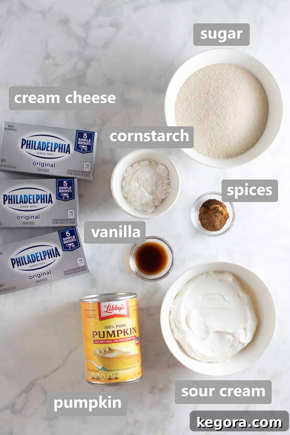 Decadent Gluten-Free Pumpkin Cheesecake 5 Overhead shot of ingredients for the pumpkin cheesecake filling, including cream cheese, sour cream, pumpkin puree, and spices.
