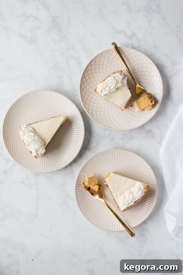 Decadent Gluten-Free Pumpkin Cheesecake 10 Slices of pumpkin cheesecake with forks on a marble background, ready for serving.