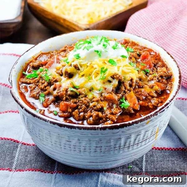 A cozy bowl of Keto Low Carb Beef Chili, generously topped with melted cheese and a dollop of sour cream, ready to be enjoyed.