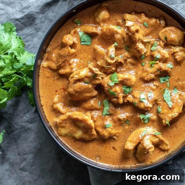 Rich and creamy Low Carb Butter Chicken served in a sleek black bowl, resting on a stylish gray napkin, highlighting its delicious texture.