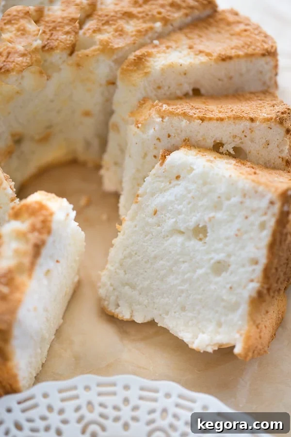 A freshly baked gluten-free angel food cake, perfectly sliced and arranged, ready for serving.