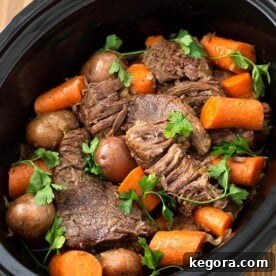 Pot Roast with vegetables in a slow cooker, ready to serve