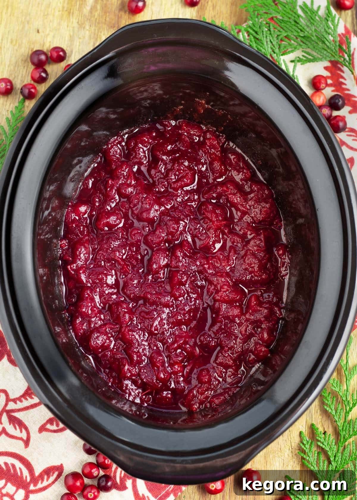 Set It and Forget It Cranberry Sauce 2 Slow Cooker Cranberry Sauce in a black crock, ready to be served
