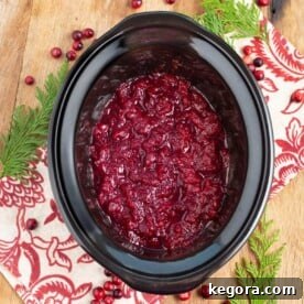 Slow Cooker Cranberry Sauce in a black crock, ready for serving