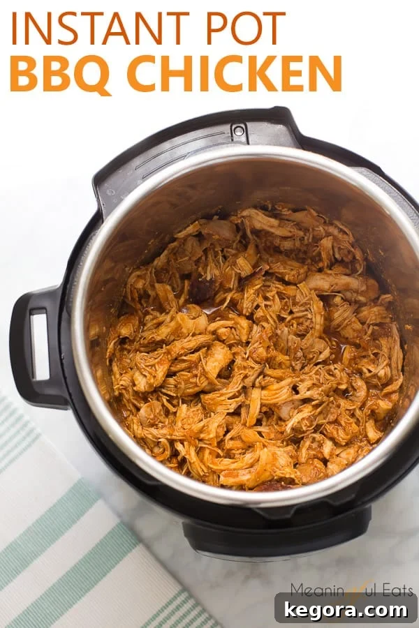 Image for Pinterest: Overhead shot of Instant Pot BBQ chicken in the pot with a white background, ready to be served