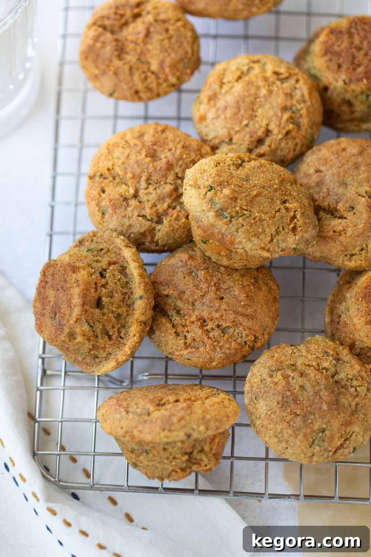 Mini Carrot Zucchini Muffins A batch of mini carrot muffins on a cooling rack