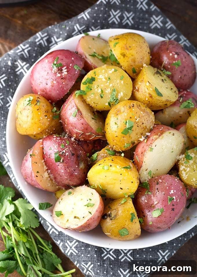 Savory Herb Butter Instant Pot Potatoes 3 Instant Pot Potatoes with Herb Butter in a white bowl on top of a black and white patterned napkin