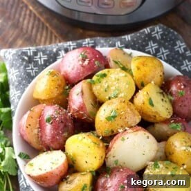 Savory Herb Butter Instant Pot Potatoes 5 Potatoes with Herb Butter in a white bowl in front of a pressure cooker