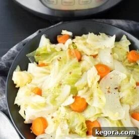 Instant Pot Cabbage Side Dish in a black bowl in front of a pressure cooker, ready to serve.