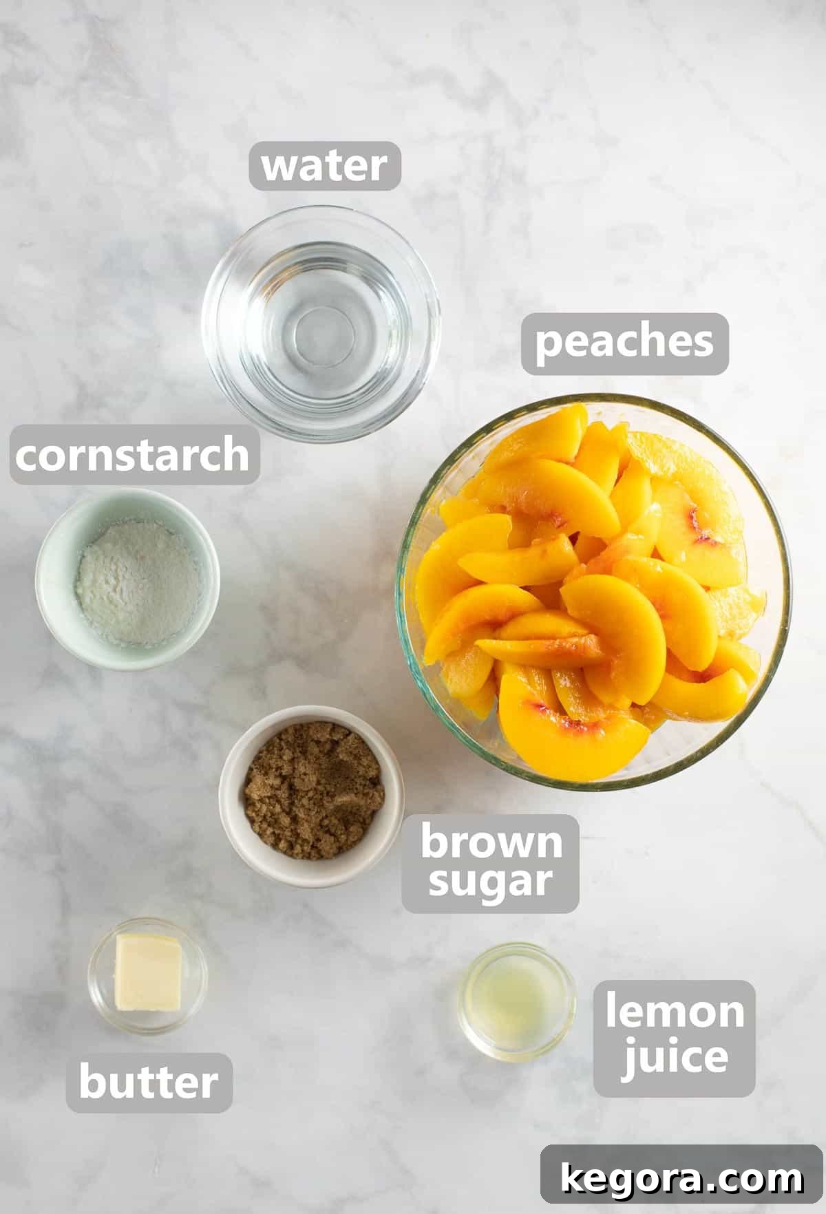 Bowls of fresh peaches, brown sugar, cornstarch, lemon juice, and butter, ready to make the delicious peach cobbler filling.
