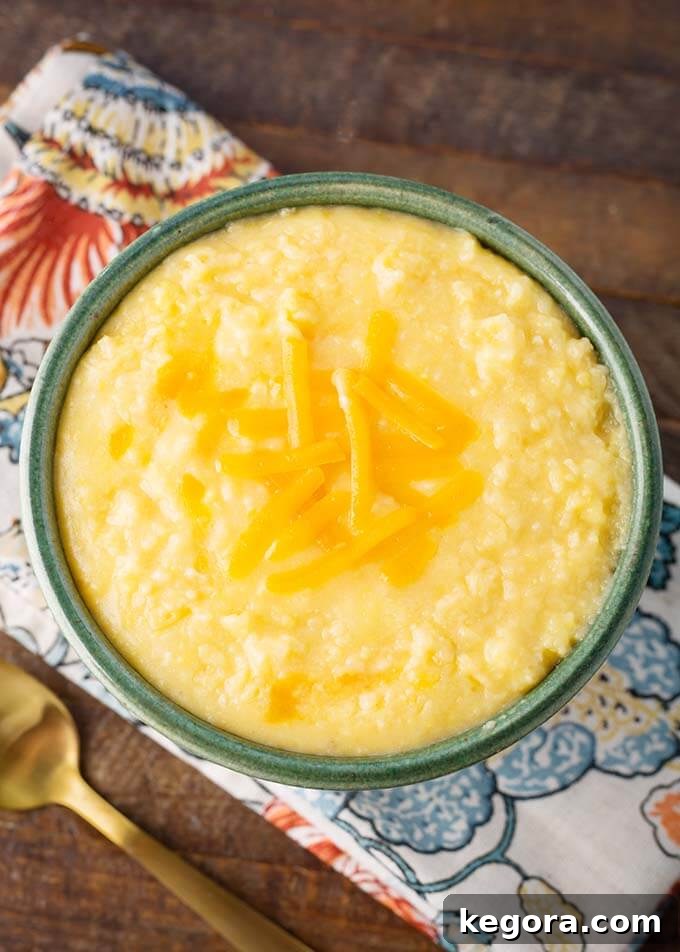 Effortless Slow Cooker Cheesy Grits 3 Slow Cooker Cheesy Grits served in a vibrant green bowl, showcasing its creamy texture.
