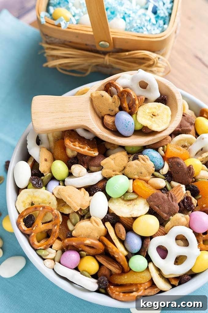 Easter Bunny's Munchie Medley 4 Bunny Bait Easter Trail Mix in a white bowl with wooden serving spoon in front of small basket