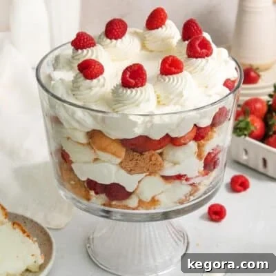 A stunning gluten-free strawberry cream cheese trifle in a clear glass dish, beautifully layered.