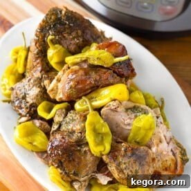 Mississippi Pork on a white platter on a wooden board