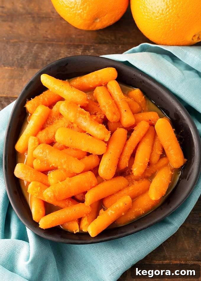 Vibrant Instant Pot Orange Maple Carrots served in a stylish black bowl, resting on a light blue napkin, ready to be enjoyed as a perfect side dish.