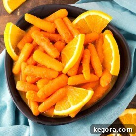 A tantalizing image of Orange Maple Carrots in a black bowl, showcasing the rich glaze and tender texture, inviting viewers to cook.