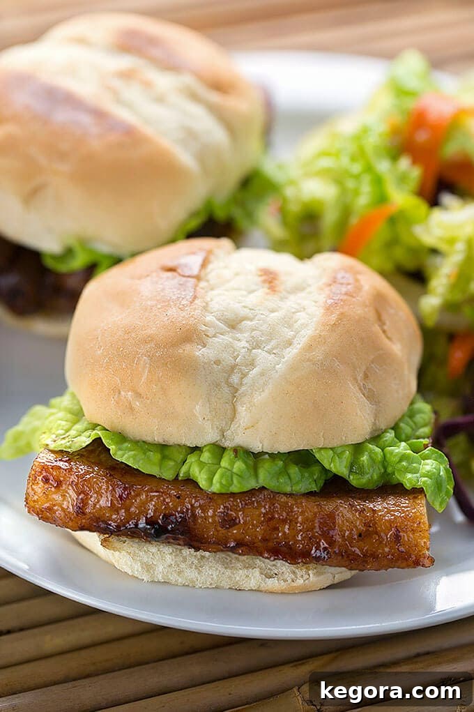 Gourmet Asian Pork Belly Bites 2 Asian Pork Belly Sliders on a white plate
