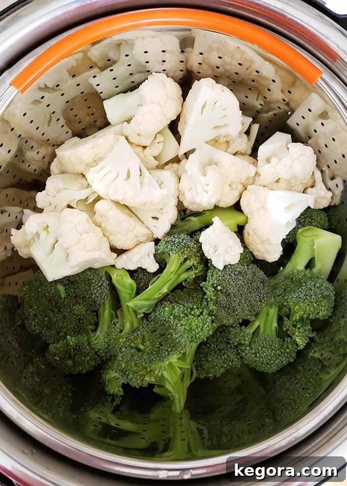 Quick & Easy Instant Pot Broccoli Cauliflower Cheese Bake 4 Broccoli Cauliflower in steamer basket in pressure cooker