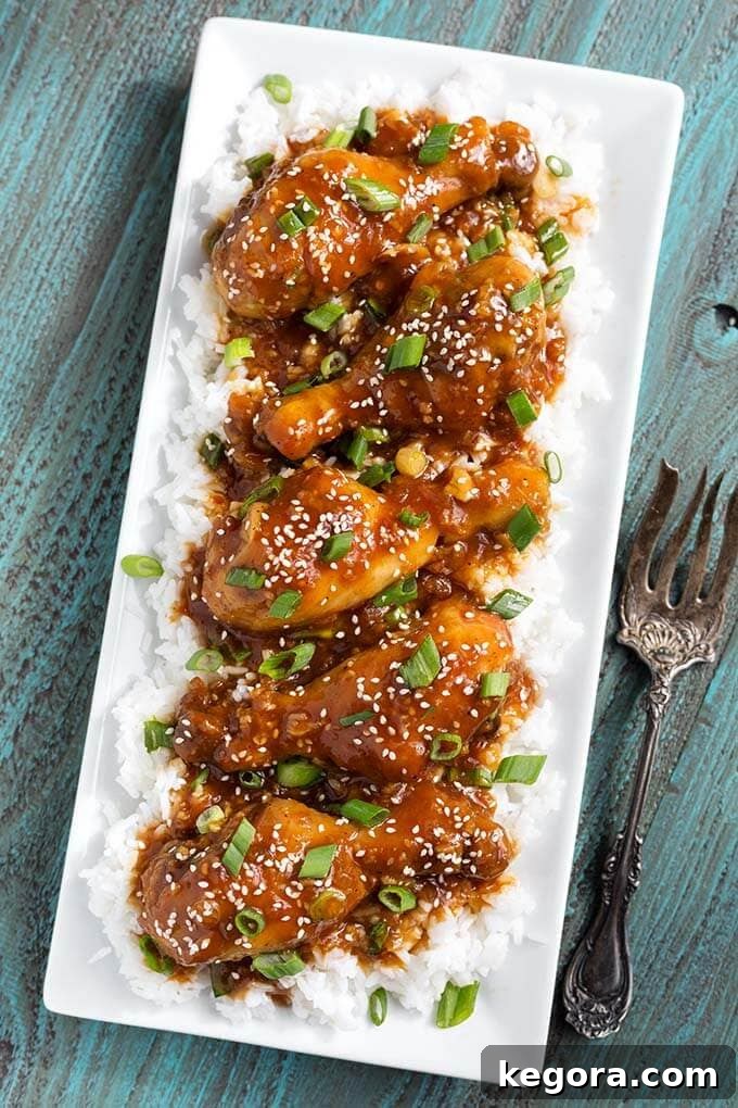 Sweet and Sticky Slow Cooker Honey Garlic Chicken 3 Honey Garlic Chicken over rice on rectangular platter
