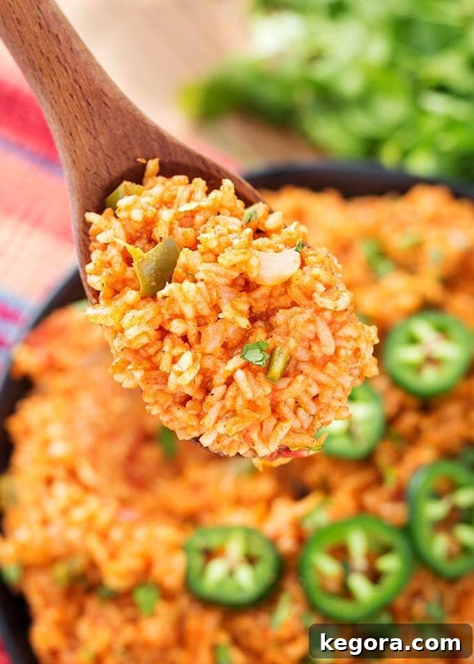 Closeup wooden spoon full of Mexican Rice