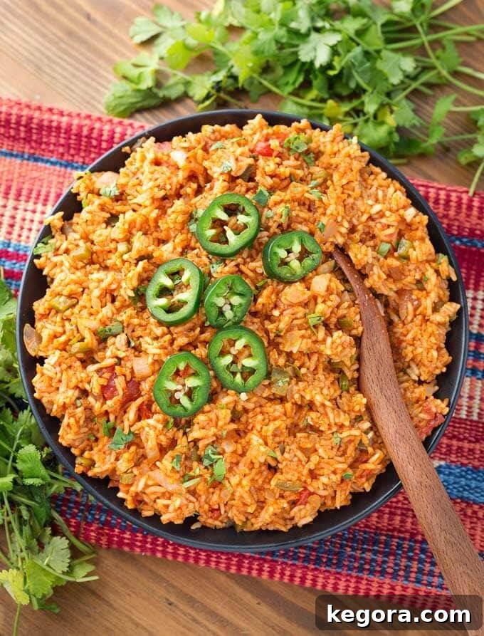 Mexican Rice in a black bowl with wooden spoon