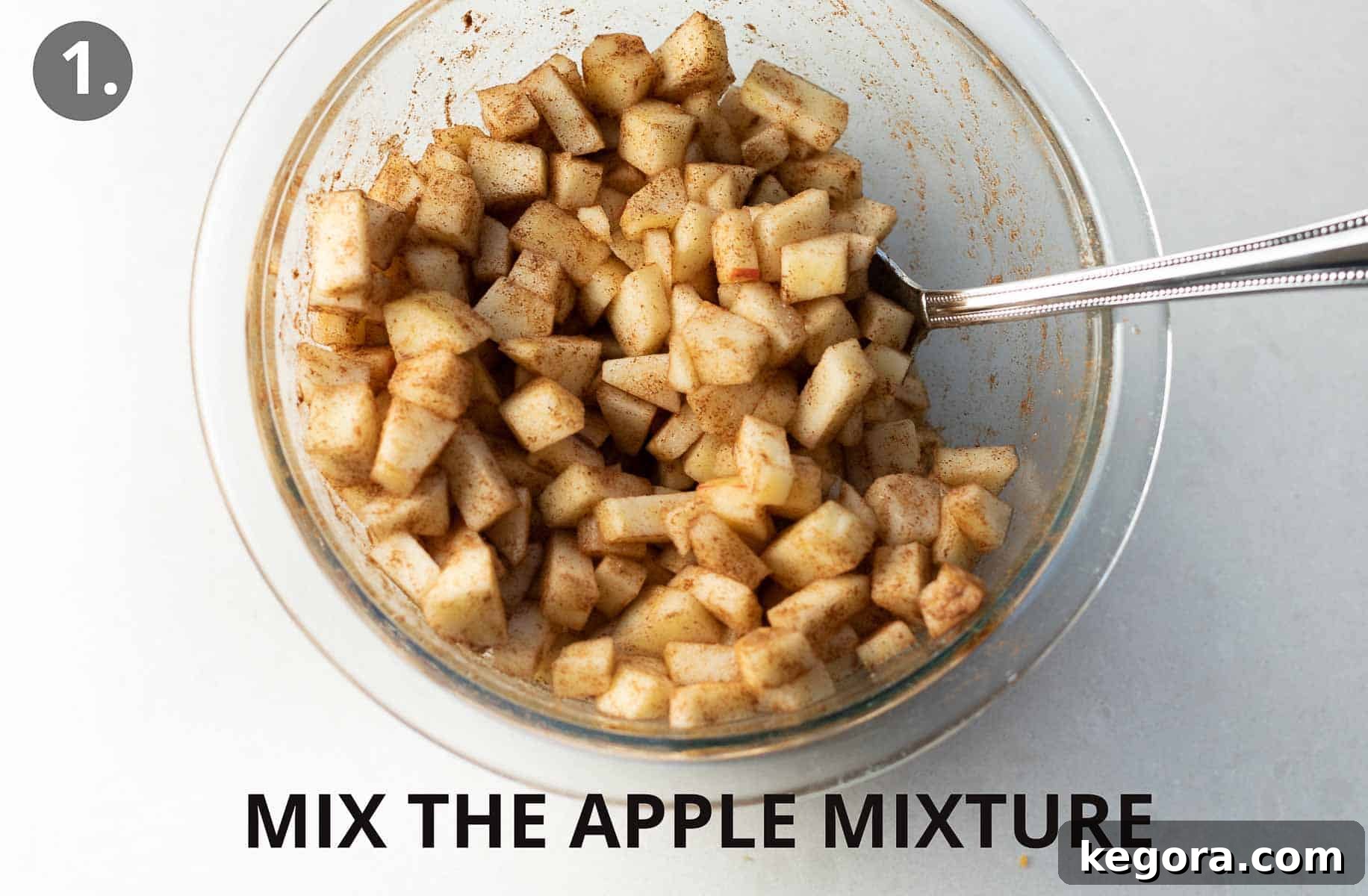 A glass bowl with the apple mixture and a spoon