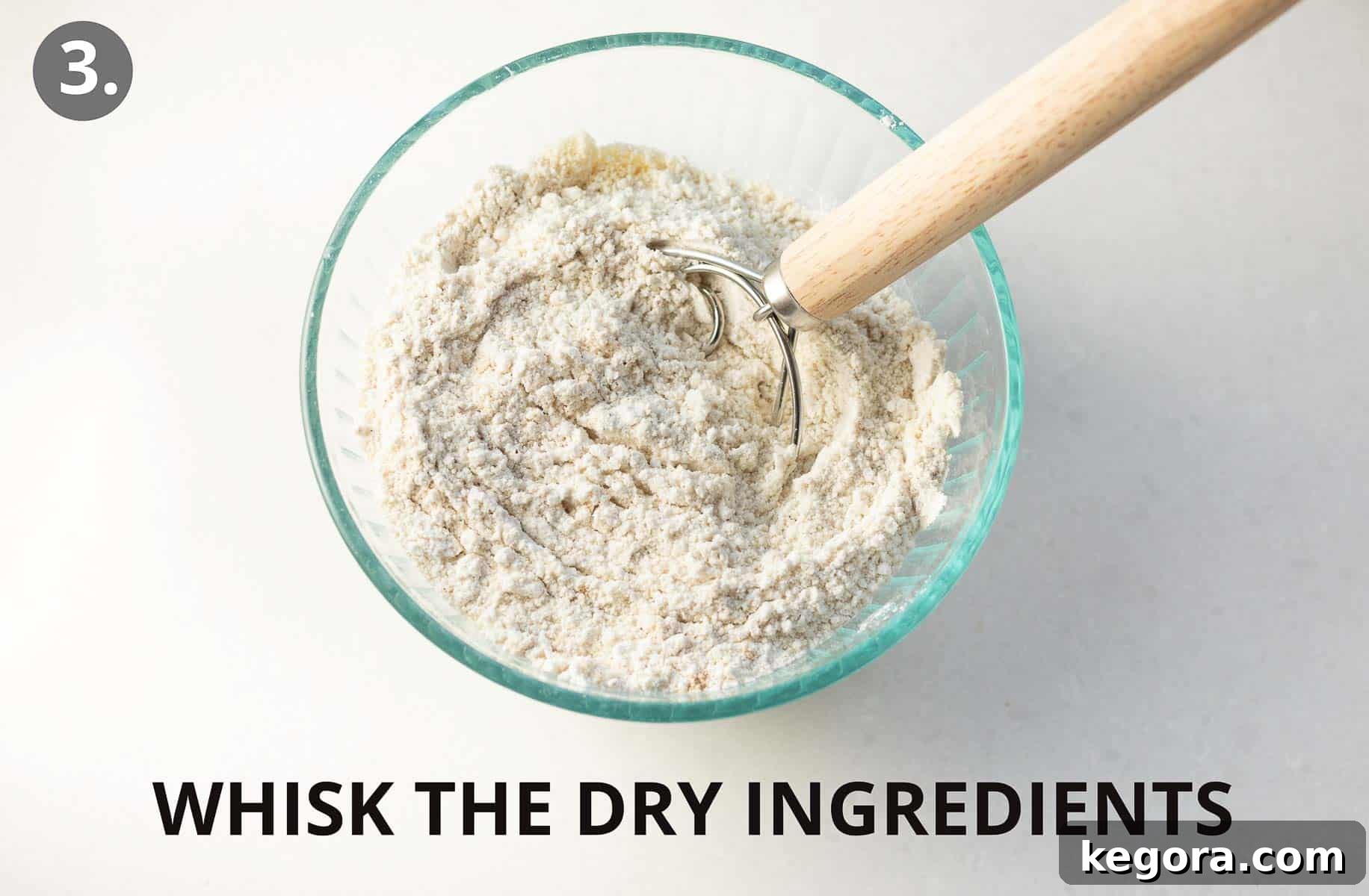 A bowl with dry ingredients and a whisk