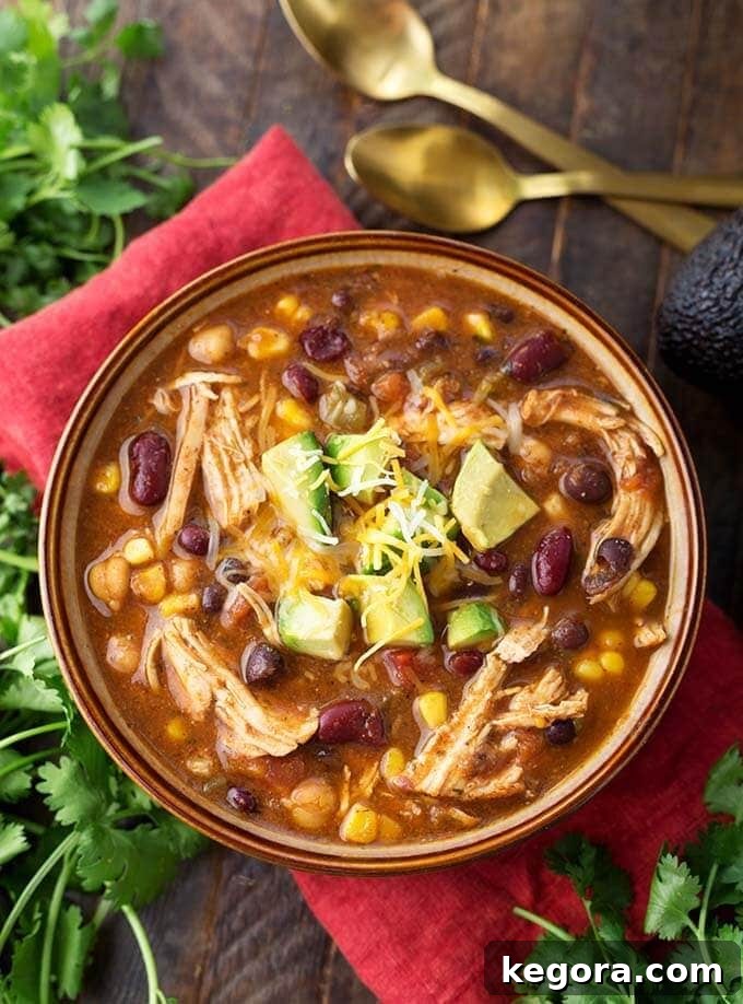 Fiesta-Ready Instant Pot Chicken Taco Soup 2 A bowl of Instant Pot Chicken Taco Soup garnished with fresh cilantro, placed on a red napkin, ready to serve.