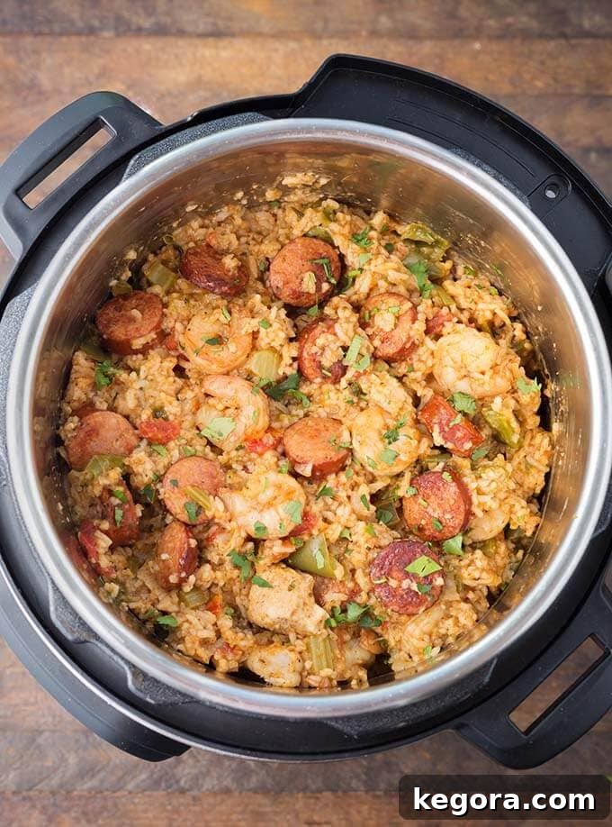 Jambalaya cooking inside a pressure cooker, showcasing the rich colors of the ingredients