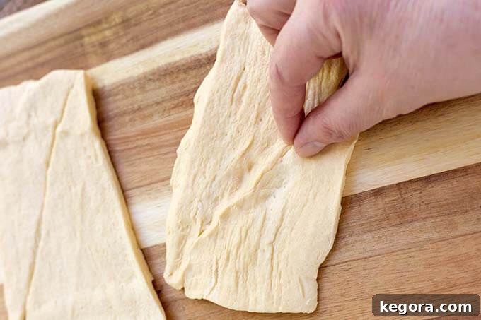 Fright Night Frank Wraps 3 hand pinching the seam of croissant dough together