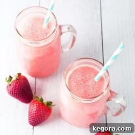 Two Strawberry Sunshine Smoothies with straws, ready to be enjoyed.