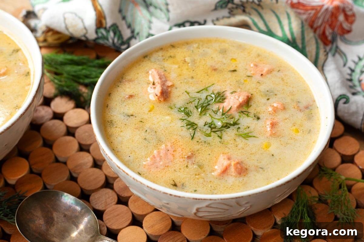 Artisan Salmon Chowder 11 A beautifully presented bowl of creamy Salmon Chowder, garnished with fresh dill, served on a white plate.