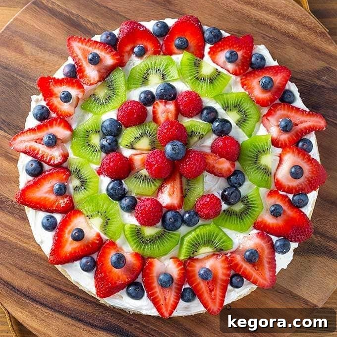 Whole Fresh Fruit Pizza presented beautifully on a round wooden board
