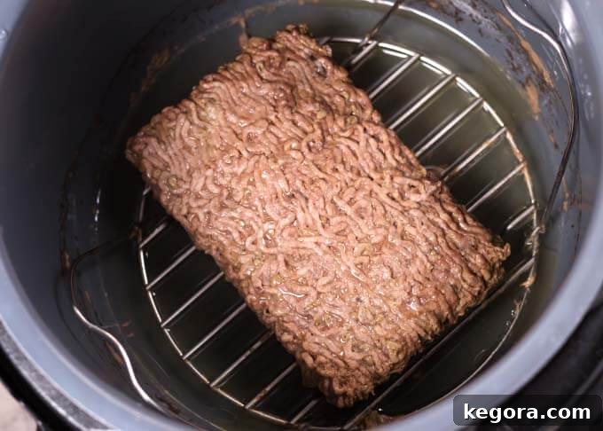 No Thaw Instant Pot Ground Beef 3 Cooked Ground Beef on trivet in pressure cooker