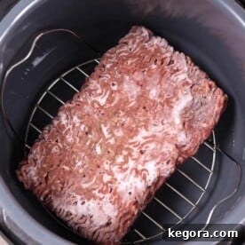 Frozen Ground Beef on trivet in a pressure cooker