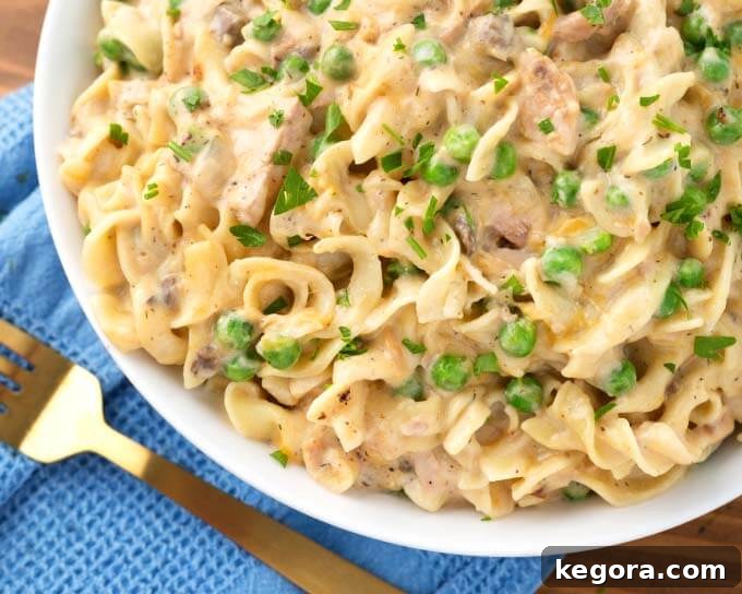 Tuna Casserole on white plate next to gold fork