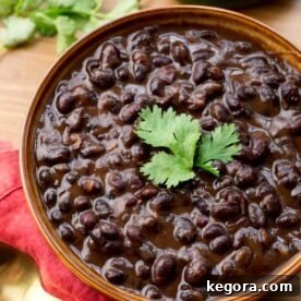 Speedy Cuban Black Beans 5 A close-up shot of rich Cuban Black Beans in a rustic brown bowl, perfectly cooked and ready to serve.