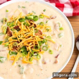 Slow Cooker Loaded Potato Soup in a white bowl