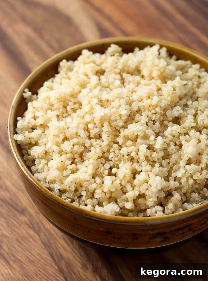 Quinoa in a brown bowl on wooden surface, perfectly cooked in Instant Pot
