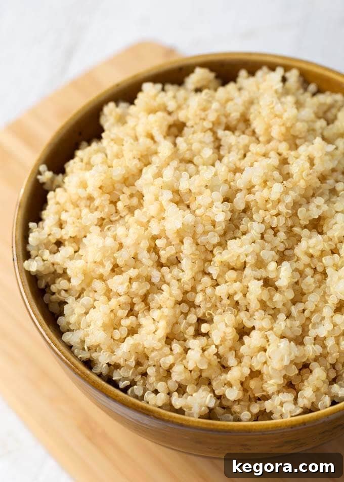 Rinsed quinoa in a brown bowl on wooden board, ready for Instant Pot
