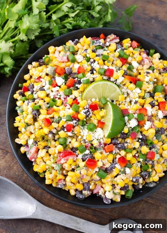 Elote Fiesta Salad 2 Mexican Street Corn Salad on a black plate on a wooden surface