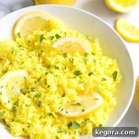Instant Pot Lemon Rice on a white plate with sliced lemons