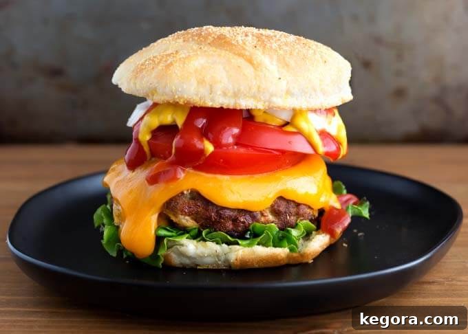 Air Fryer Turkey Burger on black plate on wooden surface