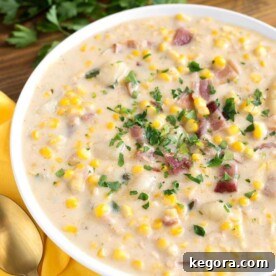 Golden Instant Pot Corn Chowder 7 Instant Pot Corn Chowder in a white bowl, garnished with parsley and bacon.