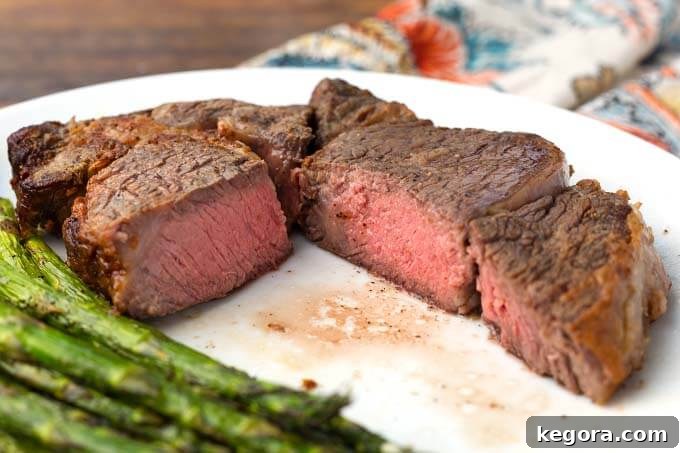 Perfect Air Fryer Ribeye Steak 3 Cut Air Fryer Rib Eye Steak with asparagus on white plate